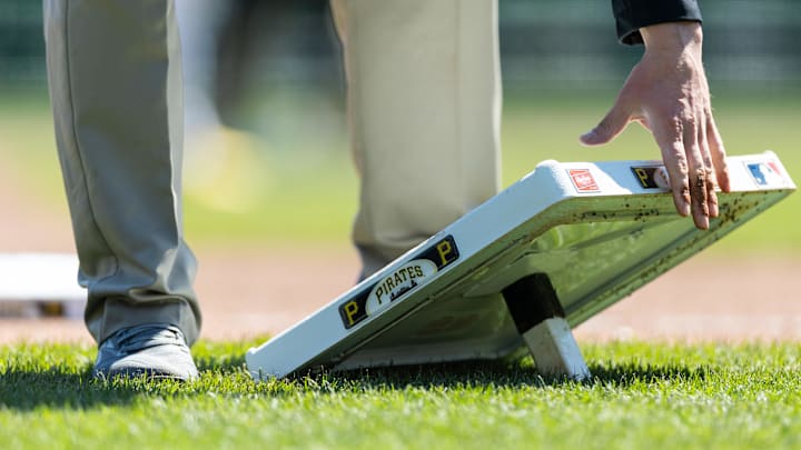 Apr 8, 2026; Pittsburgh, Pennsylvania, USA;  Pittsburgh Pirates ground crew replace the third base bag during the seventh inning against the San Diego Padres at PNC Park. Mandatory Credit: Scott Galvin-Imagn Images