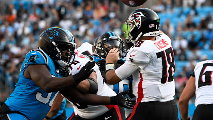 Carolina Panthers defensive tackle T.J. Smith pressures as Atlanta Falcons quarterback Kirk Cousins throws a pass. Carolina Panthers defensive tackle T.J. Smith pressures as Atlanta Falcons quarterback Kirk Cousins throws a pass.