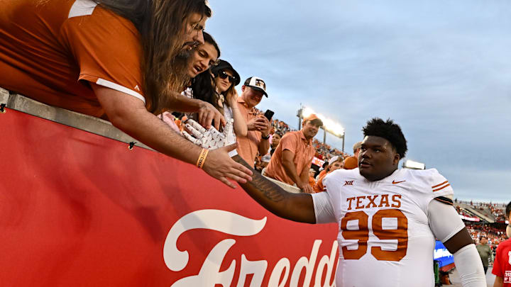 Oct 21, 2023; Houston, Texas, USA; Texas Longhorns defensive lineman Sydir Mitchell (99) high fives fans after the game against the Houston Cougars at TDECU Stadium. Mandatory Credit: Maria Lysaker-Imagn Images