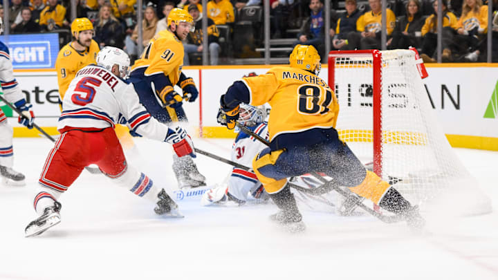 Dec 17, 2024; Nashville, Tennessee, USA;  Nashville Predators center Jonathan Marchessault (81) scores past New York Rangers goaltender Igor Shesterkin (31) during the first period at Bridgestone Arena. Mandatory Credit: Steve Roberts-Imagn Images