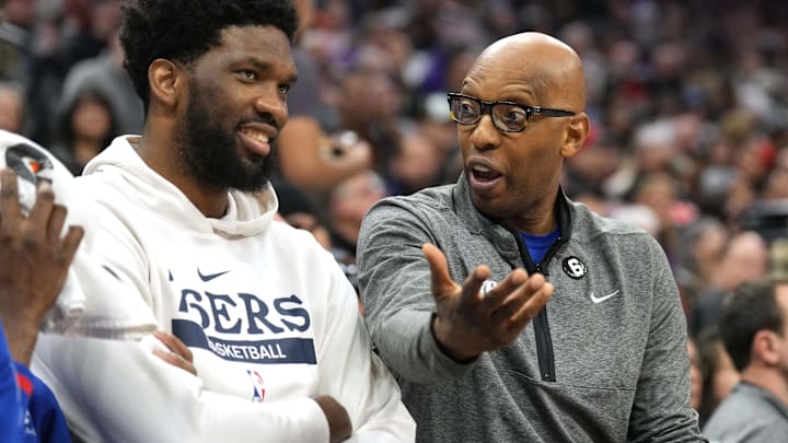 Jan 21, 2023; Sacramento, California, USA; Philadelphia 76ers assistant coach Sam Cassell (right) talks to center Joel Embiid (left) during the second quarter against the Sacramento Kings at Golden 1 Center. Mandatory Credit: Darren Yamashita-Imagn Images