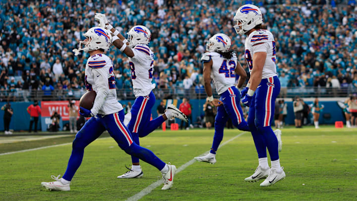 Buffalo Bills safety Cole Bishop (24), from left, celebrates his interception, sealing the game, with safety Sam Franklin Jr. (28), linebacker Dorian Williams (42) and linebacker Matt Milano (58), during the fourth quarter of an NFL football AFC Wild Card playoff matchup, Sunday, Jan. 11, 2026