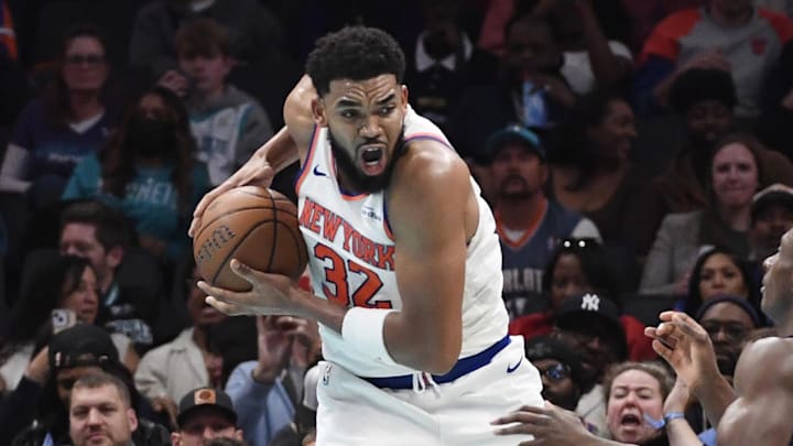 Nov 26, 2025; Charlotte, North Carolina, USA; New York Knicks center Karl-Anthony Towns (32) gets a rebound during the second half against the Charlotte Hornets at the Spectrum Center. Mandatory Credit: Sam Sharpe-Imagn Images