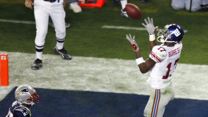 Feb 3, 2008; Glendale, AZ, USA; New York Giants wide receiver Plaxico Burress (17) catches the game-winning touchdown in front of New England Patriots cornerback Ellis Hobbs (27) in the fourth during Super Bowl XLII at the University of Phoenix Stadium.  The New York Giants defeated the New England Patriots 17-14.   