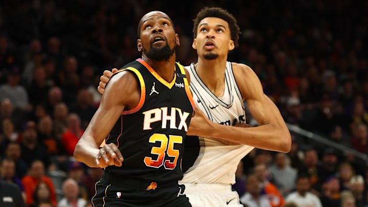 Dec 3, 2024; Phoenix, Arizona, USA; Phoenix Suns forward Kevin Durant (35) against San Antonio Spurs center Victor Wembanyama (1) in the first half of an NBA Cup game at Footprint Center. Mandatory Credit: Mark J. Rebilas-Imagn Images
