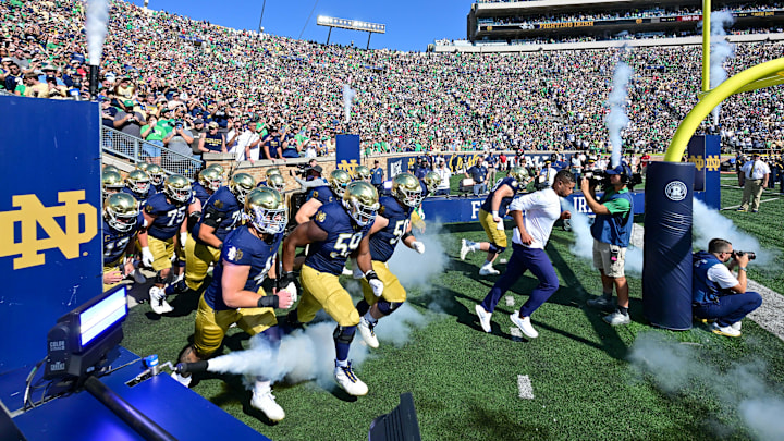 Sep 21, 2024; South Bend, Indiana, USA; Notre Dame Fighting Irish head coach Marcus Freeman leads his team onto the field for the game against the Miami Redhawks at Notre Dame Stadium. Mandatory Credit: Matt Cashore-Imagn Images