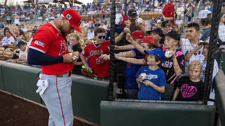 Feb 28, 2025; Phoenix, Arizona, USA; Los Angeles Angels third baseman Yoan Moncada signs autographs prior to the game against the Los Angeles Dodgers during spring training at Camelback Ranch-Glendale. Mandatory Credit: Mark J. Rebilas-Imagn Images