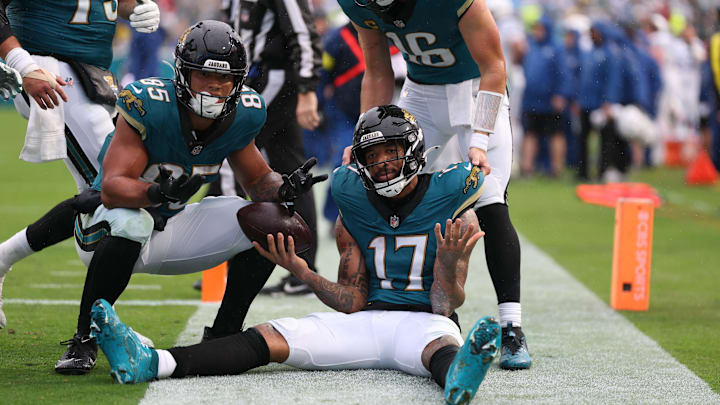 Dec 7, 2025; Jacksonville, Florida, USA; Jacksonville Jaguars wide receiver Tim Patrick (17) sits on the field after catching a touchdown pass, as teammates tight end Brenton Strange (85) and quarterback Trevor Lawrence (16) join in against the Indianapolis Colts during the first half at EverBank Stadium. Mandatory Credit: Matt Pendleton-Imagn Images Dec 7, 2025; Jacksonville, Florida, USA; Jacksonville Jaguars wide receiver Tim Patrick (17) sits on the field after catching a touchdown pass, as teammates tight end Brenton Strange (85) and quarterback Trevor Lawrence (16) join in against the Indianapolis Colts during the first half at EverBank Stadium. Mandatory Credit: Matt Pendleton-Imagn Images