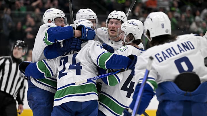 Apr 8, 2025; Dallas, Texas, USA; Vancouver Canucks left wing Jake DeBrusk (74) and center Pius Suter (24) and right wing Brock Boeser (6) and right wing Conor Garland (8) and defenseman Filip Hronek (17) and defenseman Quinn Hughes (43) celebrates the game tying goal scored by Suter against the Dallas Stars during the third period at the American Airlines Center. Mandatory Credit: Jerome Miron-Imagn Images