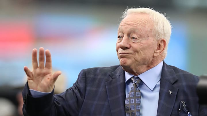 Dallas Cowboys owner Jerry Jones waves on the field prior to the game against the Detroit Lions at AT&T Stadium 