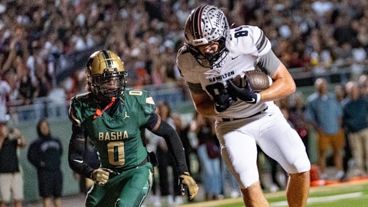 Hamilton Huskies jumps to catch the ball while Basha Bears attempts to catch up to him during a game at Basha High School in Chandler on Oct. 24, 2025.