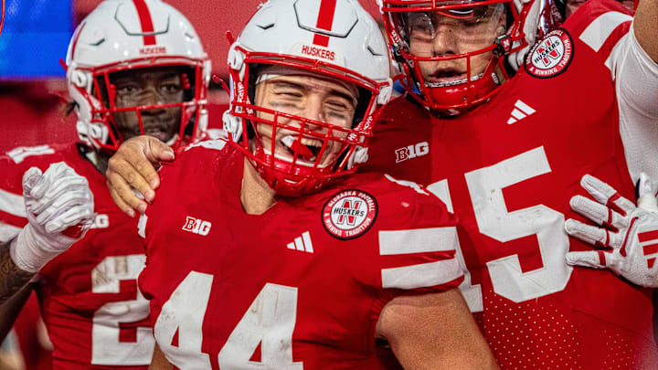 From left, running back Emmett Johnson, tight end Luke Lindenmeyer and quarterback Dylan Raiola celebrate after a touchdown against Akron.