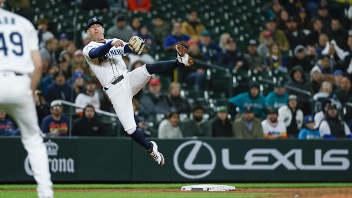 Seattle Mariners third baseman Dylan Moore throws to first base for a double play to end the top of the eleventh inning against the Houston Astros at T-Mobile Park.