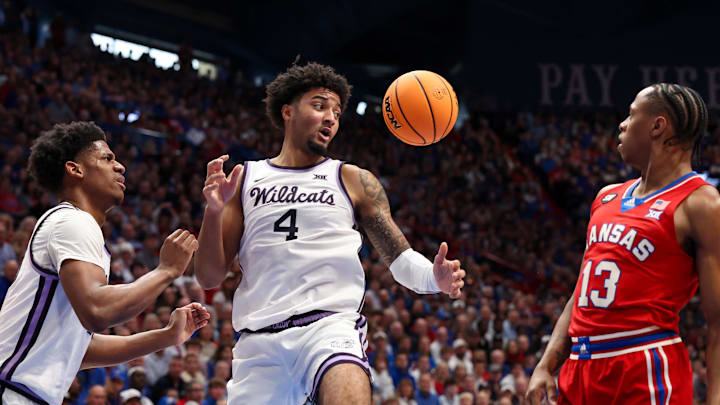 Mar 7, 2026; Lawrence, Kansas, USA; Kansas Jayhawks guard Elmarko Jackson (13) and Kansas State Wildcats guard P.J. Haggerty (4) and forward Taj Manning (15) go after a loose ball during the first half at Allen Fieldhouse. Mar 7, 2026; Lawrence, Kansas, USA; Kansas Jayhawks guard Elmarko Jackson (13) and Kansas State Wildcats guard P.J. Haggerty (4) and forward Taj Manning (15) go after a loose ball during the first half at Allen Fieldhouse.