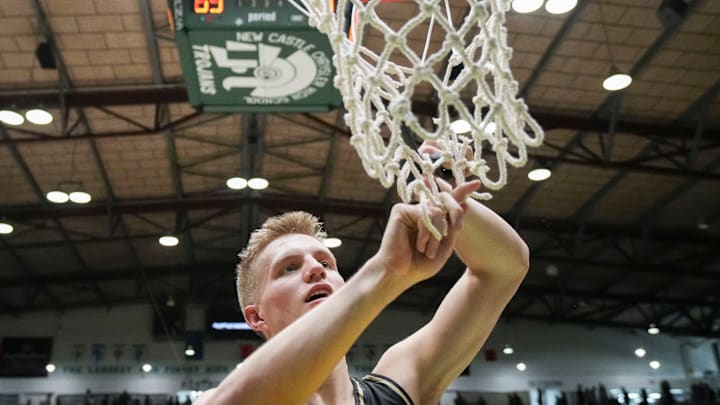 Mt. Vernon Marauders Luke Ertel (12) cuts a piece of the net Saturday, March 21, 2026, during a Class 4A semistate championship game at New Castle Fieldhouse in New Castle, Ind. The Mt. Vernon Marauders defeated the New Albany Bulldogs, 77-69.