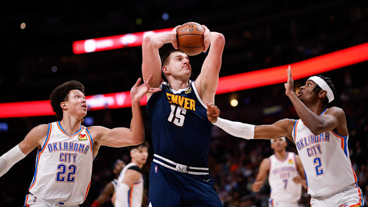 Mar 2, 2022; Denver, Colorado, USA; Denver Nuggets center Nikola Jokic (15) controls the ball as Oklahoma City Thunder forward Isaiah Roby (22) and guard Shai Gilgeous-Alexander (2) guard in the second quarter at Ball Arena. Mandatory Credit: Isaiah J. Downing-Imagn Images