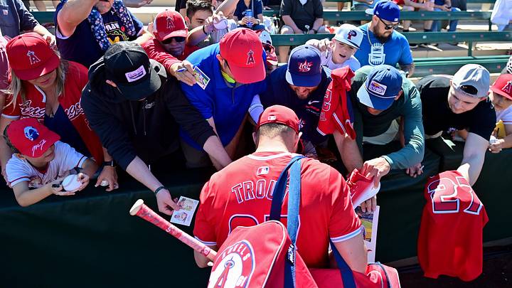 Feb 29, 2024; Tempe, Arizona, USA; Los Angeles Angels center fielder Mike Trout (27) signs autographs for fans prior to a spring training game against the Cleveland Guardians at Tempe Diablo Stadium. Mandatory Credit: Matt Kartozian-USA TODAY Sports Feb 29, 2024; Tempe, Arizona, USA; Los Angeles Angels center fielder Mike Trout (27) signs autographs for fans prior to a spring training game against the Cleveland Guardians at Tempe Diablo Stadium. Mandatory Credit: Matt Kartozian-USA TODAY Sports