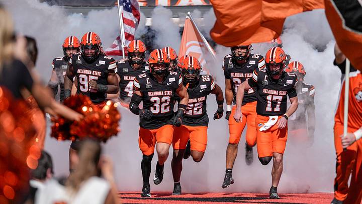 OSU players run on the field. OSU players run on the field.