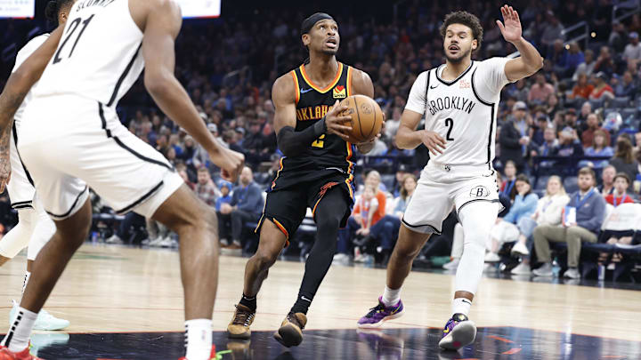 Jan 19, 2025; Oklahoma City, Oklahoma, USA; Oklahoma City Thunder guard Shai Gilgeous-Alexander (2) drives to the basket between Brooklyn Nets forwards Noah Clowney (21) and Cameron Johnson (2) during the second half at Paycom Center. Mandatory Credit: Alonzo Adams-Imagn Images