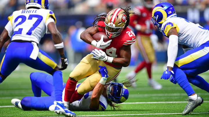 Sep 22, 2024; Inglewood, California, USA; San Francisco 49ers running back Jordan Mason (24) runs the ball against Los Angeles Rams cornerback Tre'Davious White (27) during the first half at SoFi Stadium. Mandatory Credit: Gary A. Vasquez-Imagn Images Sep 22, 2024; Inglewood, California, USA; San Francisco 49ers running back Jordan Mason (24) runs the ball against Los Angeles Rams cornerback Tre'Davious White (27) during the first half at SoFi Stadium. Mandatory Credit: Gary A. Vasquez-Imagn Images