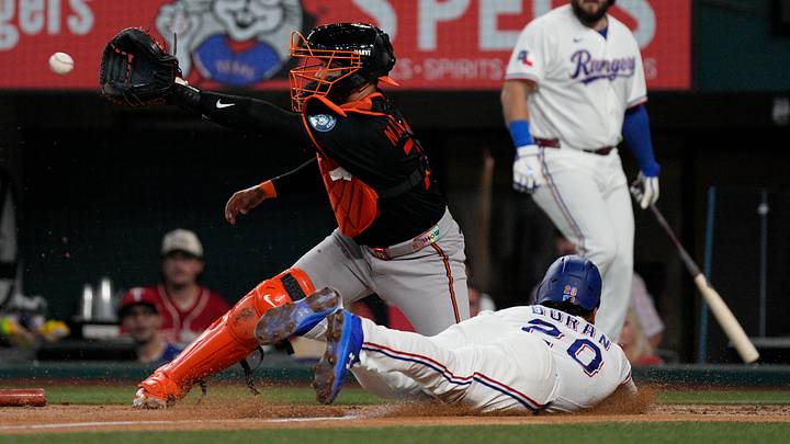 Aug 8, 2026; Arlington, Texas, USA; Texas Rangers shortstop Ezequiel Duran (20) slides into home plate to score as Baltimore Orioles catcher Carlos Narvaez (75) awaits the throw during the second inning at Globe Life Field. Mandatory Credit: Raymond Carlin III-Imagn Images Aug 8, 2026; Arlington, Texas, USA; Texas Rangers shortstop Ezequiel Duran (20) slides into home plate to score as Baltimore Orioles catcher Carlos Narvaez (75) awaits the throw during the second inning at Globe Life Field. Mandatory Credit: Raymond Carlin III-Imagn Images