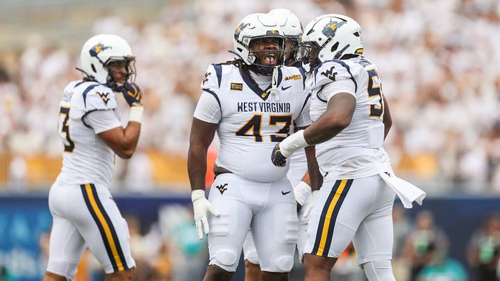 Sep 5, 2026; Morgantown, West Virginia, USA; West Virginia Mountaineers defensive lineman K.J. Henson (43) celebrates with teammates after a defensive stop during the third quarter against the Coastal Carolina Chanticleers at Milan Puskar Stadium. Mandatory Credit: Ben Queen-Imagn Images