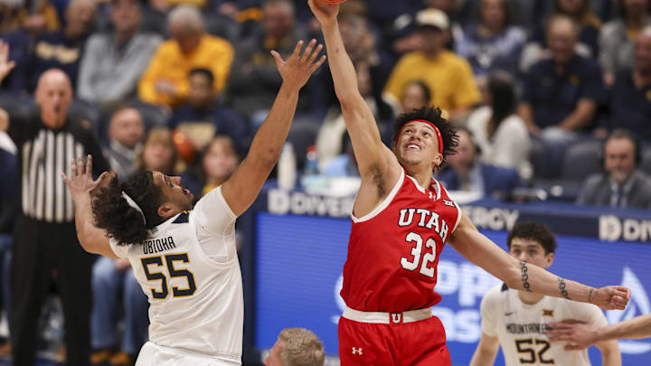 Feb 18, 2026; Morgantown, West Virginia, USA; Utah Utes forward James Okonkwo (32) and West Virginia Mountaineers center Harlan Obioha (55) jump for the tip at Hope Coliseum. Mandatory Credit: Ben Queen-Imagn Images