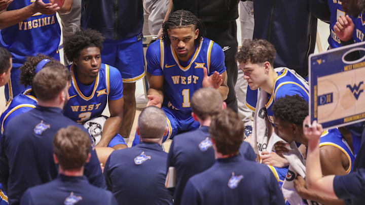 Jan 31, 2026; Morgantown, West Virginia, USA; West Virginia Mountaineers head coach Ross Hodge talks to his players during a timeout during the second half against the Baylor Bears at Hope Coliseum. Mandatory Credit: Ben Queen-Imagn Images