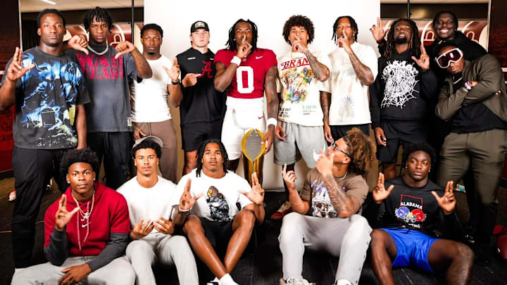 Alabama five-star commit Jireh Edwards poses with several members of the Crimson Tide football team on an official visit in June