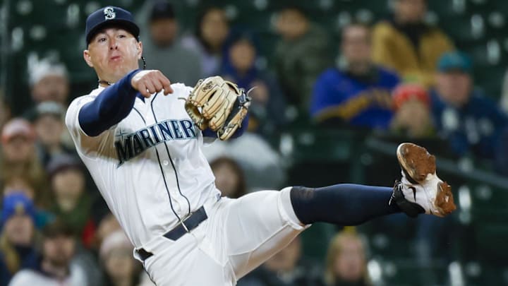 Seattle Mariners third baseman Dylan Moore throws to first to complete a double play against the Houston Astros on April 8 at T-Mobile Park. Seattle Mariners third baseman Dylan Moore throws to first to complete a double play against the Houston Astros on April 8 at T-Mobile Park.