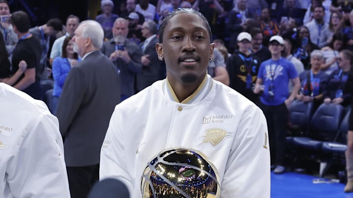 Oct 21, 2025; Oklahoma City, Oklahoma, USA; Oklahoma City Thunder guard Jalen Williams carries the Larry O'Brien Championship Trophy during the ring ceremony before the start of a their game against the Houston Rockets during the first half at Paycom Center. Mandatory Credit: Alonzo Adams-Imagn Images