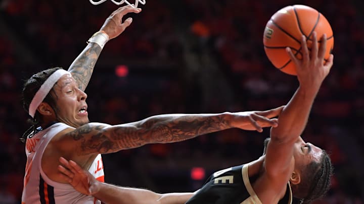 Mar 7, 2025; Champaign, Illinois, USA;  Purdue Boilermakers guard C.J. Cox (0) drives to the basket as Illinois Fighting Illini guard Tre White (22) defends during the second half at State Farm Center. Mandatory Credit: Ron Johnson-Imagn Images
