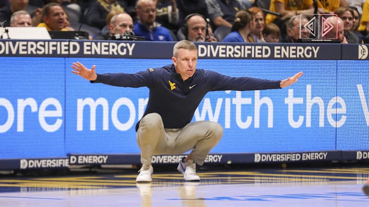 Feb 28, 2026; Morgantown, West Virginia, USA; West Virginia Mountaineers head coach Ross Hodge watched a play from the sideline during the first half against the BYU Cougars at Hope Coliseum. Mandatory Credit: Ben Queen-Imagn Images