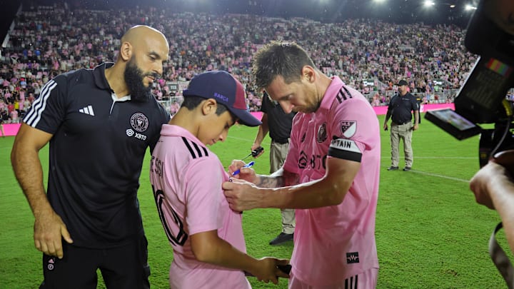 Oct 7, 2023; Fort Lauderdale, Florida, USA; Inter Miami CF forward Lionel Messi (10) signs an autograph after the game against FC Cincinnati at DRV PNK Stadium. Mandatory Credit: Sam Navarro-Imagn Images