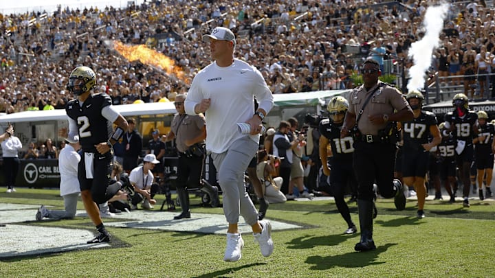 Oct 18, 2025; Orlando, Florida, USA;  Central Florida Knights head coach Scott Frost leads the team on to the field prior to a game against the West Virginia Mountaineers at Acrisure Bounce House. Mandatory Credit: Russell Lansford-Imagn Images