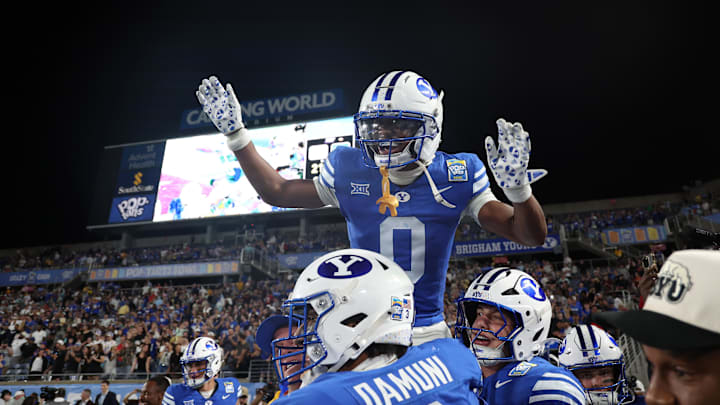 Dec 27, 2025; Orlando, FL, USA; BYU Cougars cornerback Evan Johnson (0) ) is congratulated after he intercepted the ball against the Georgia Tech Yellow Jackets during the second half at Camping World Stadium. Mandatory Credit: Kim Klement Neitzel-Imagn Images