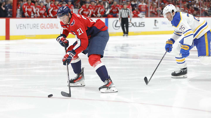 Mar 30, 2025; Washington, District of Columbia, USA; Washington Capitals center Aliaksei Protas (21) skates with the puck past Buffalo Sabres defenseman Owen Power (25) to score a goal during the third period at Capital One Arena. Mandatory Credit: Amber Searls-Imagn Images