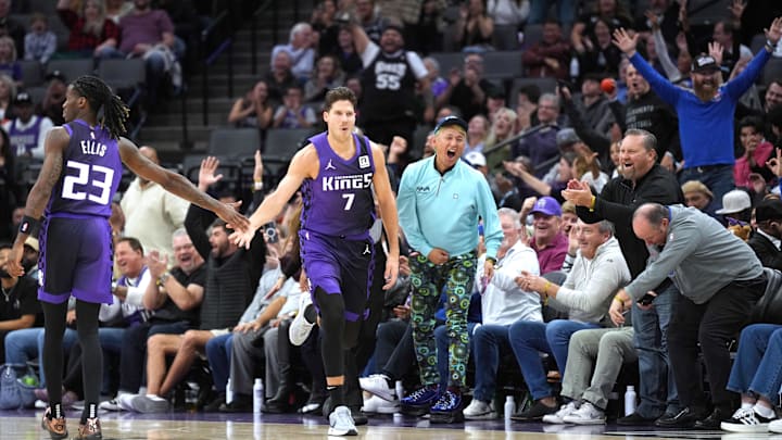 Dec 8, 2024; Sacramento, California, USA; Sacramento Kings forward Doug McDermott (7) is congratulated by guard Keon Ellis (23) after making a three point basket against the Utah Jazz during the fourth quarter at Golden 1 Center. Mandatory Credit: Darren Yamashita-Imagn Images