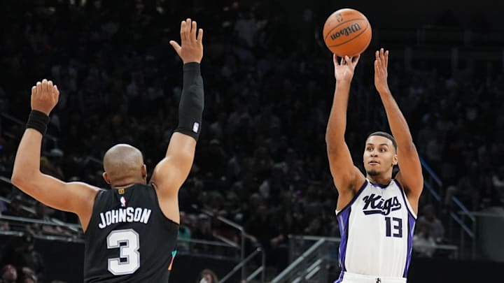 Feb 21, 2026; Austin, Texas, USA;  Sacramento Kings forward Keegan Murray (13) shoots over San Antonio Spurs forward Keldon Johnson (3) in the second half at Moody Center. Mandatory Credit: Daniel Dunn-Imagn Images