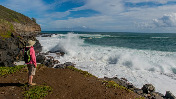 A woman (model released) is watching the heavy surf at...