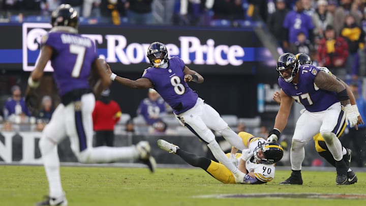 Baltimore Ravens quarterback Lamar Jackson (8) attempts to throw the ball while defended by Pittsburgh Steelers Baltimore Ravens quarterback Lamar Jackson (8) attempts to throw the ball while defended by Pittsburgh Steelers