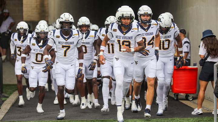 Sep 5, 2026; Morgantown, West Virginia, USA; West Virginia Mountaineers players run onto the field before their game against the Coastal Carolina Chanticleers at Milan Puskar Stadium. Mandatory Credit: Ben Queen-Imagn Images