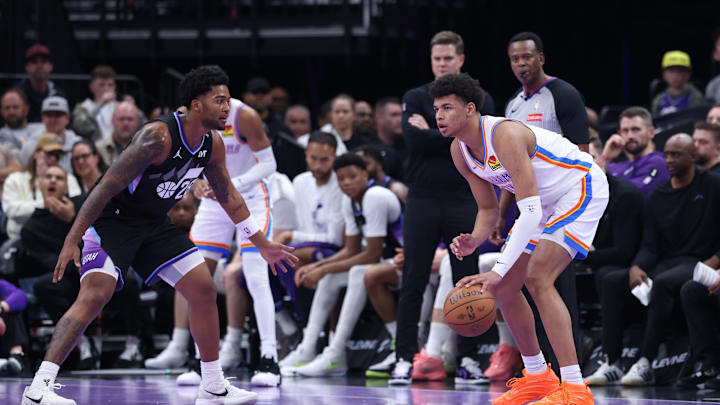 Nov 21, 2025; Salt Lake City, Utah, USA; Oklahoma City Thunder forward Ousmane Dieng (13) looks to pass as Utah Jazz forward Brice Sensabaugh (28) defends during the second half at Delta Center. Mandatory Credit: Rob Gray-Imagn Images