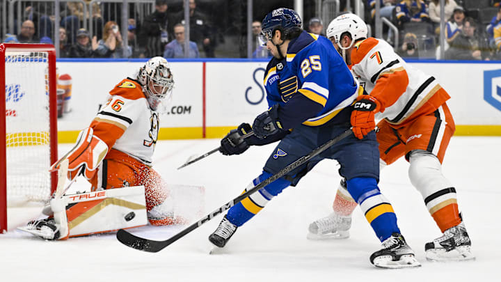 Jan 9, 2025; St. Louis, Missouri, USA;  Anaheim Ducks goaltender John Gibson (36) and defenseman Radko Gudas (7) defend the net against St. Louis Blues center Jordan Kyrou (25) during the second period at Enterprise Center. Mandatory Credit: Jeff Curry-Imagn Images