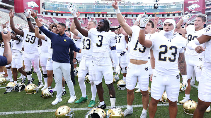 Sep 27, 2025; Fayetteville, Arkansas, USA; Notre Dame Fighting Irish head coach Marcus Freeman leads the team in celebration after the game against the Arkansas Razorbacks at Donald W. Reynolds Razorback Stadium. Notre Dame won 56-13. Mandatory Credit: Nelson Chenault-Imagn Images