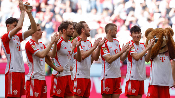 Bayern Munich players applauding fans at Allianz Arena after 2-1 win against Eintracht Frankfurt.