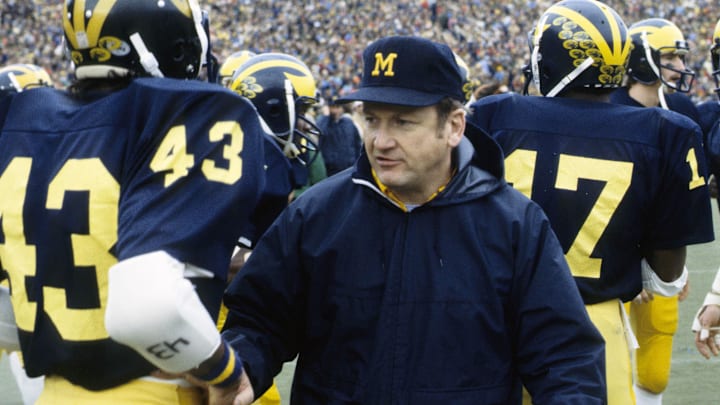 Michigan head coach Bo Schembechler on the field with his players at Michigan Stadium during the 1977 season.