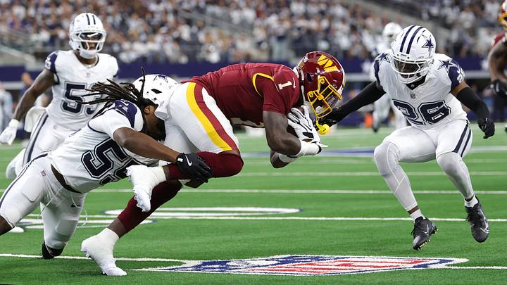 Dallas Cowboys linebacker Jaishawn Barham (55) tackles Washington Commanders running back Rachaad White (1) during the first half at AT&T Stadium.