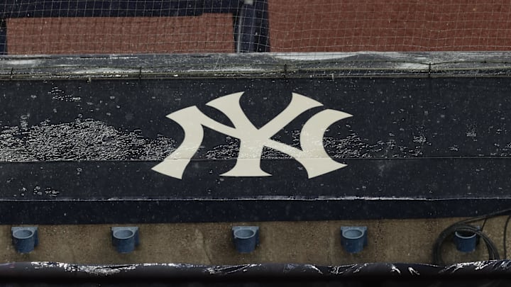 Aug 17, 2020; Bronx, New York, USA; A general view of rain falling on the  New York Yankees logo on the first base dugout roof during a rain delay in the game between the New York Yankees and the Boston Red Sox. Mandatory Credit: Vincent Carchietta-Imagn Images