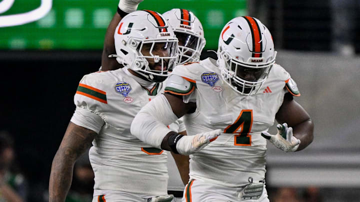 Dec 31, 2025; Arlington, TX, USA; Miami Hurricanes defensive lineman Rueben Bain Jr. (4) and defensive lineman Akheem Mesidor (3) celebrates after sacking Ohio State Buckeyes quarterback Julian Sayin (not pictured) during the 2025 Cotton Bowl and quarterfinal game of the College Football Playoff at AT&T Stadium.